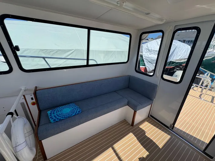 Resolute Yacht Photos Pics Interior of 2020 Cape Powercat 3500 PH with blue seating and large windows.