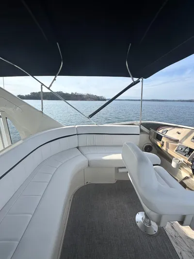  Yacht Photos Pics 2005 Carver 39 Motor Yacht interior with white seating and helm, overlooking serene waters.