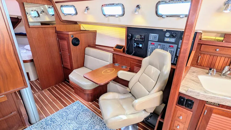 Offline Yacht Photos Pics Interior of 2019 Island Packet 349 yacht with seating, control panel, and wooden finishes.