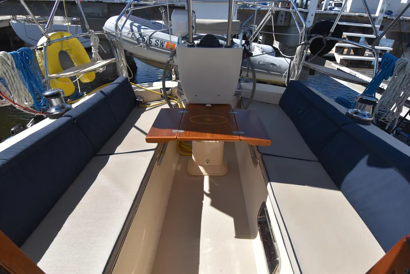 Offline Yacht Photos Pics 2019 Island Packet 349 sailboat cockpit with seating and wooden table.