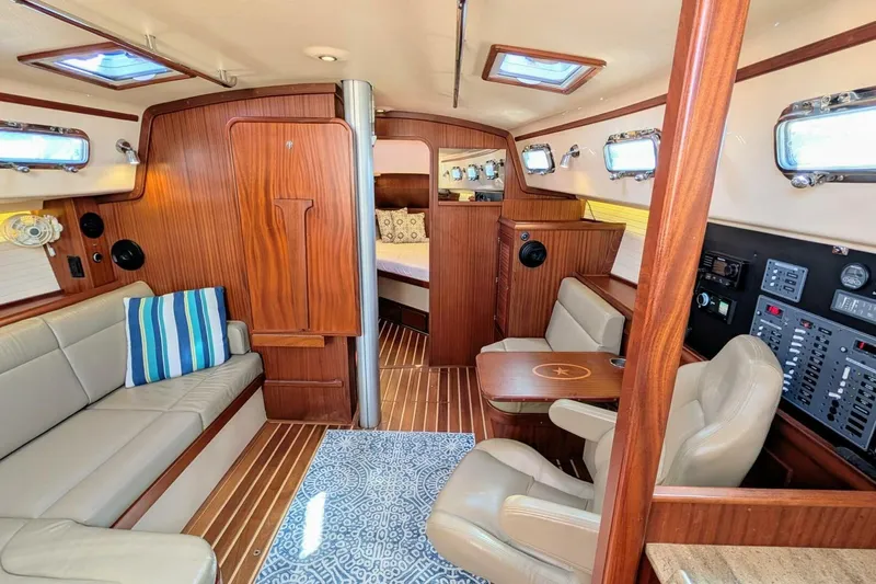 Offline Yacht Photos Pics 2019 Island Packet 349 yacht interior with elegant wood finish and comfortable seating.
