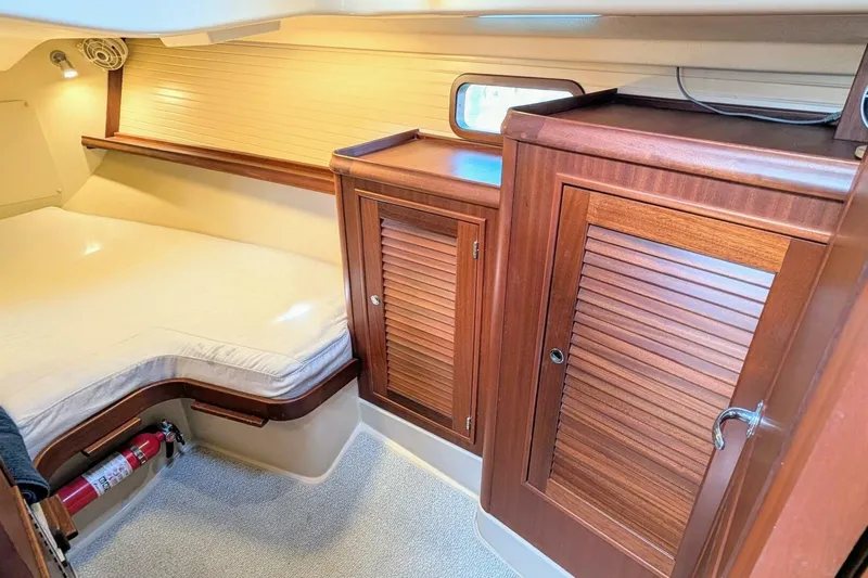 Offline Yacht Photos Pics 2019 Island Packet 349 cabin interior with wooden cabinets and cozy bed.