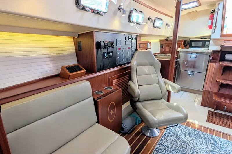 Offline Yacht Photos Pics Interior of 2019 Island Packet 349 yacht with modern seating and navigation panel.