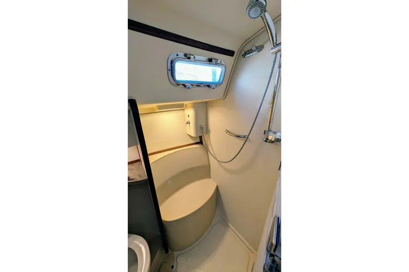 Offline Yacht Photos Pics Bathroom interior of 2019 Island Packet 349 yacht with shower and porthole window.