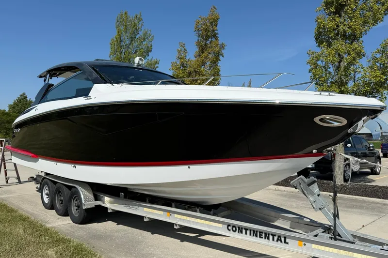  Yacht Photos Pics 2019 Cobalt A36 boat on trailer, sleek black and white design, parked outdoors.