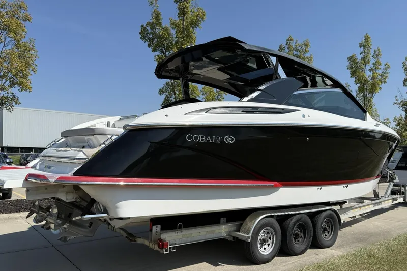  Yacht Photos Pics 2019 Cobalt A36 boat on trailer, black and white design, parked outdoors.