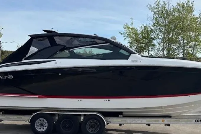  Yacht Photos Pics 2019 Cobalt A36 boat on trailer, black and white design, parked outdoors.