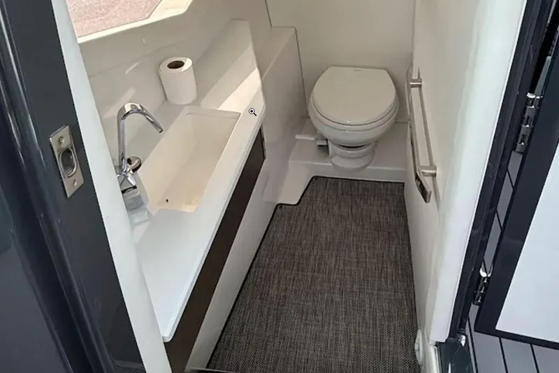  Yacht Photos Pics 2019 Cobalt A36 boat bathroom with sink, toilet, and carpeted floor.