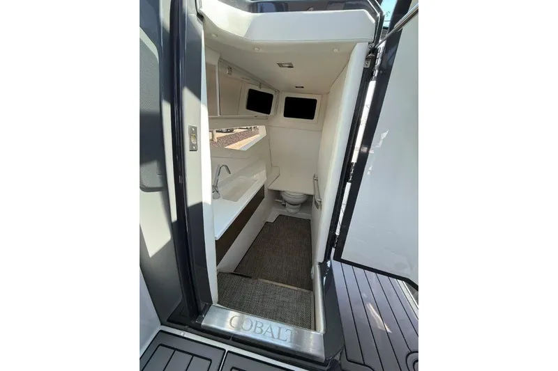  Yacht Photos Pics Interior of 2019 Cobalt A36 boat showing compact bathroom with sink and toilet.