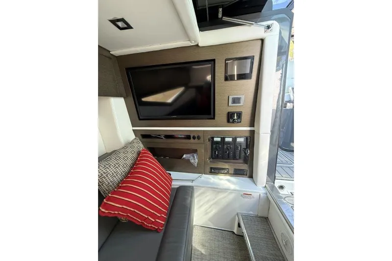  Yacht Photos Pics Interior of 2019 Cobalt A36 boat with TV, control panel, and cushions.