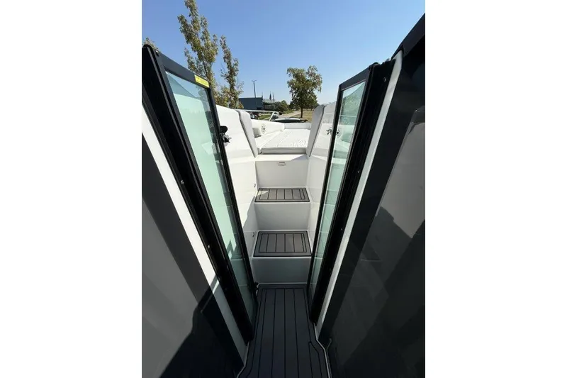  Yacht Photos Pics 2019 Cobalt A36 boat interior with open glass doors and steps, under clear blue sky.