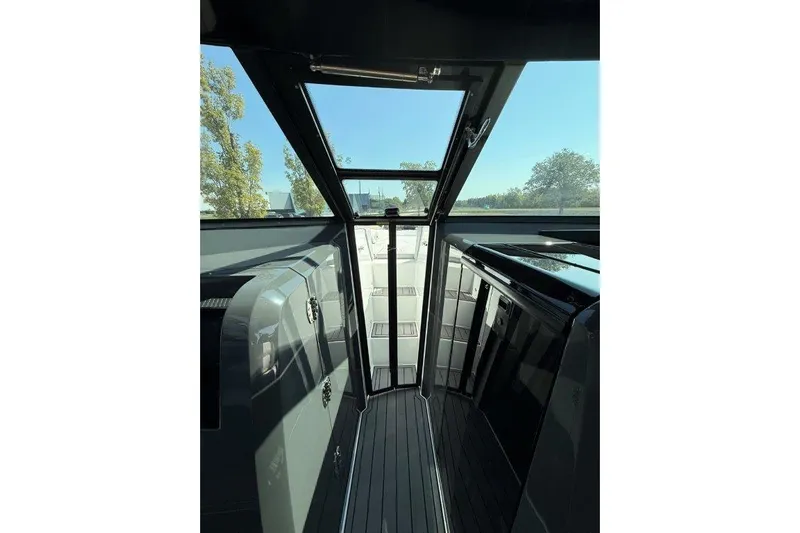  Yacht Photos Pics Interior view of a 2019 Cobalt A36 boat with sleek design and glass door.