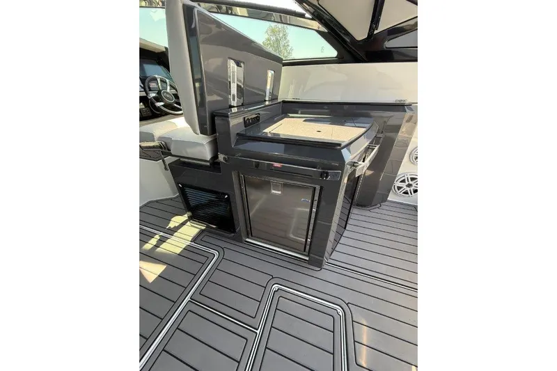  Yacht Photos Pics 2019 Cobalt A36 boat interior with sleek kitchenette and modern flooring.