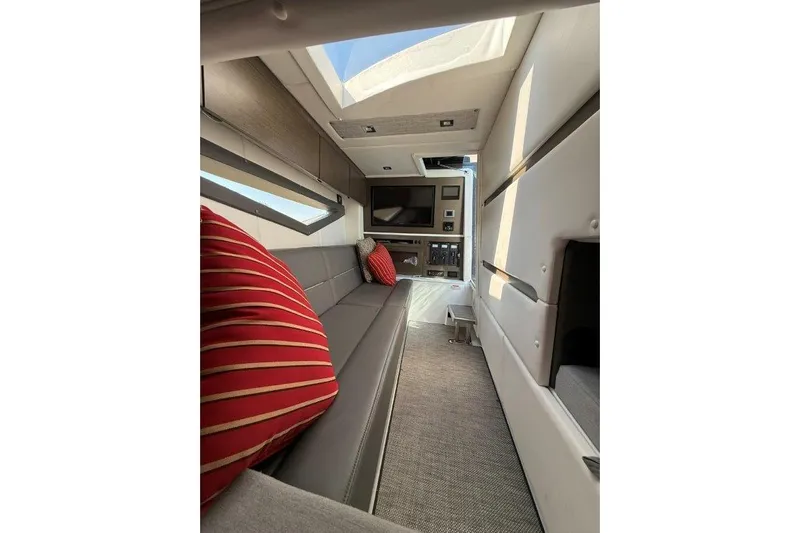  Yacht Photos Pics Interior of 2019 Cobalt A36 boat with modern seating and red-striped pillows.