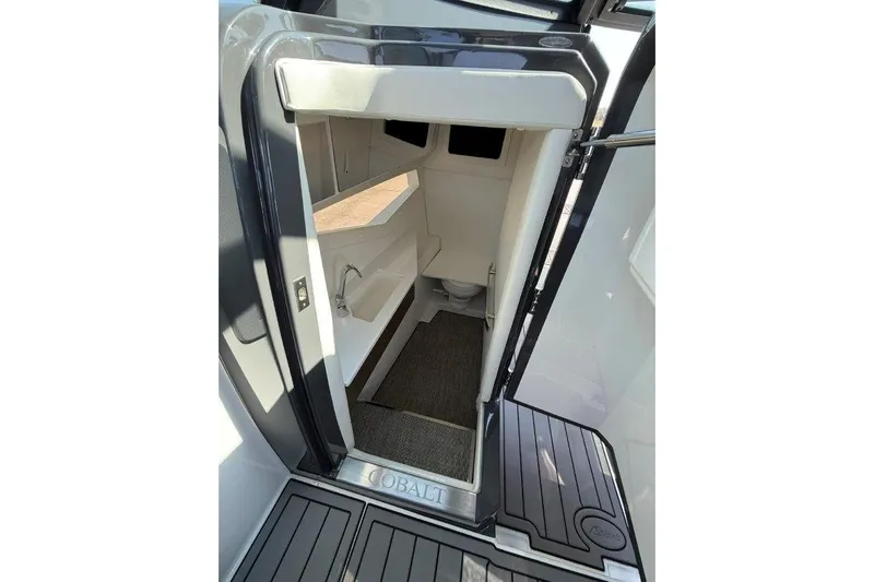 Yacht Photos Pics 2019 Cobalt A36 boat interior cabin with sink and carpeted floor.