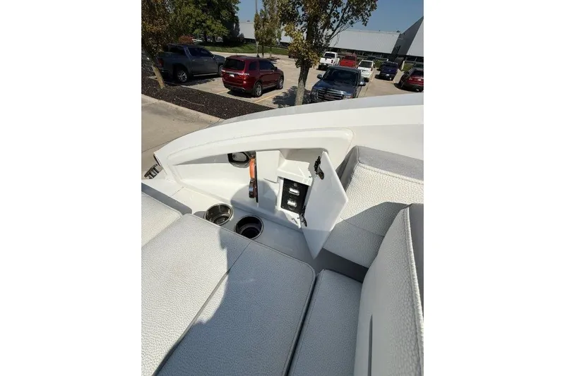  Yacht Photos Pics 2019 Cobalt A36 boat interior with open storage compartment and cup holders.