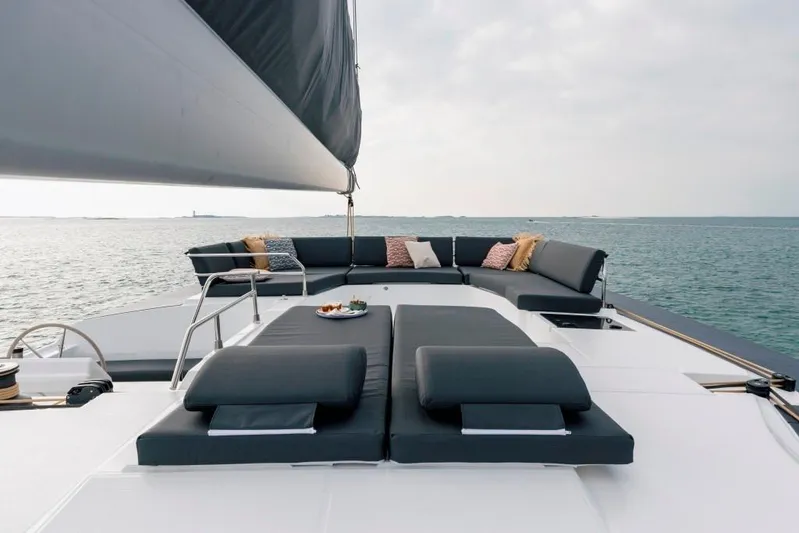  Yacht Photos Pics 2025 Fountaine Pajot Catamaran Aura 51 with luxurious deck seating on the ocean.