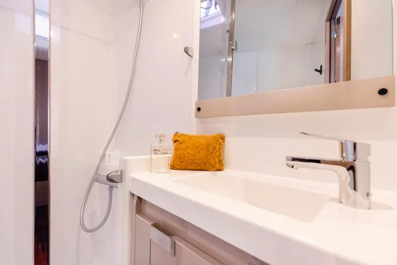  Yacht Photos Pics Modern bathroom in 2025 Fountaine Pajot Catamaran Aura 51, featuring sleek fixtures and elegant design.