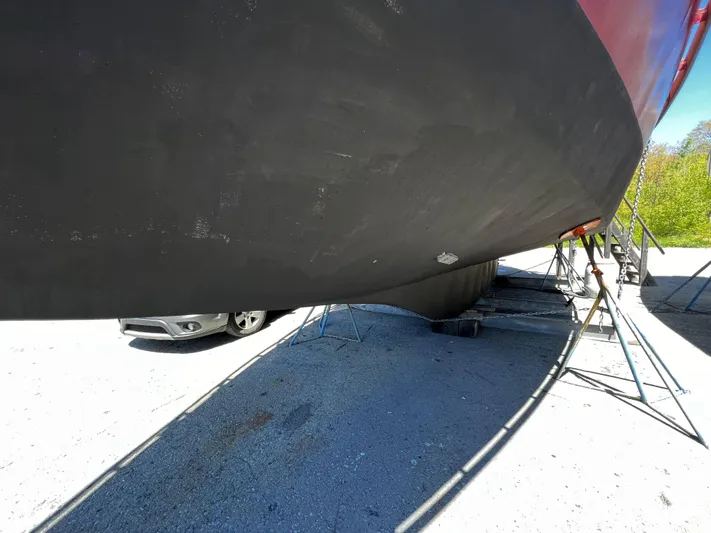 Melodeon Yacht Photos Pics Custom Seakindly Marine Tucker 52 yacht hull, 2006 model, on dry dock with car nearby.