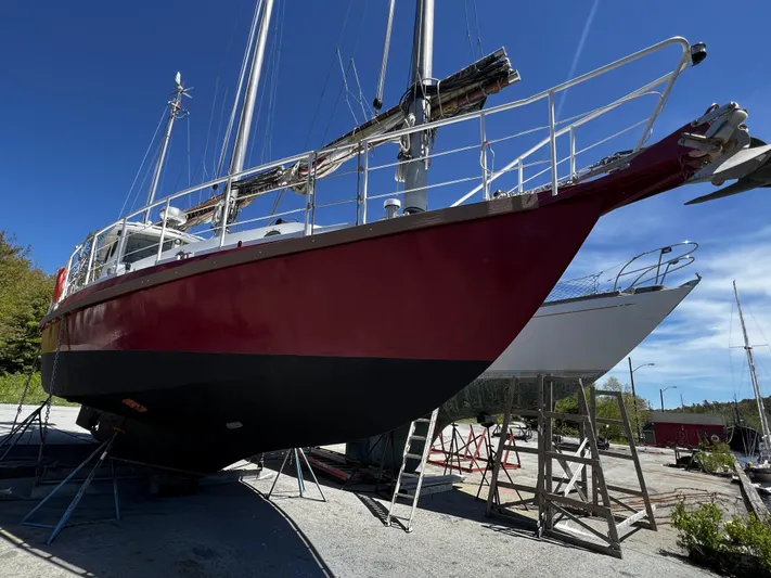 Melodeon Yacht Photos Pics Custom Seakindly Marine Tucker 52 sailboat, 2006 model, on dry dock under clear blue sky.