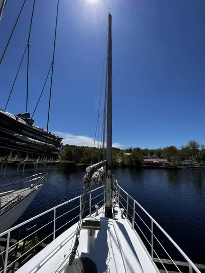 Melodeon Yacht Photos Pics Sailboat deck view of 2006 Seakindly Marine Tucker 52 under clear blue sky.