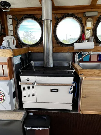 Melodeon Yacht Photos Pics Marine kitchen with stove and portholes on 2006 Seakindly Marine Tucker 52 boat.
