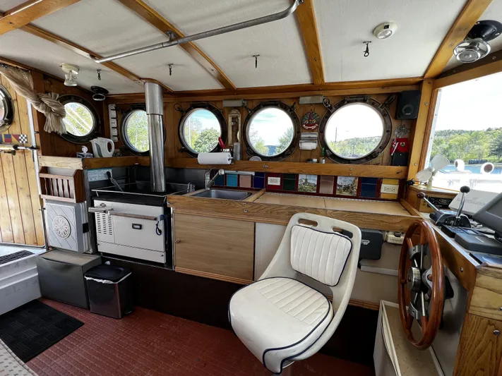 Melodeon Yacht Photos Pics Interior of 2006 Custom Seakindly Marine Tucker 52 with nautical decor and helm.