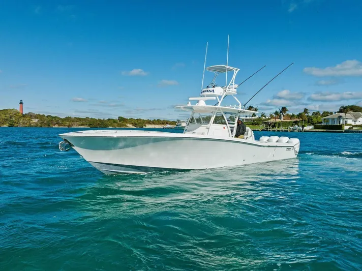 Ohana Yacht Photos Pics 2019 Invincible 42 Open Fisherman boat cruising on clear blue water.