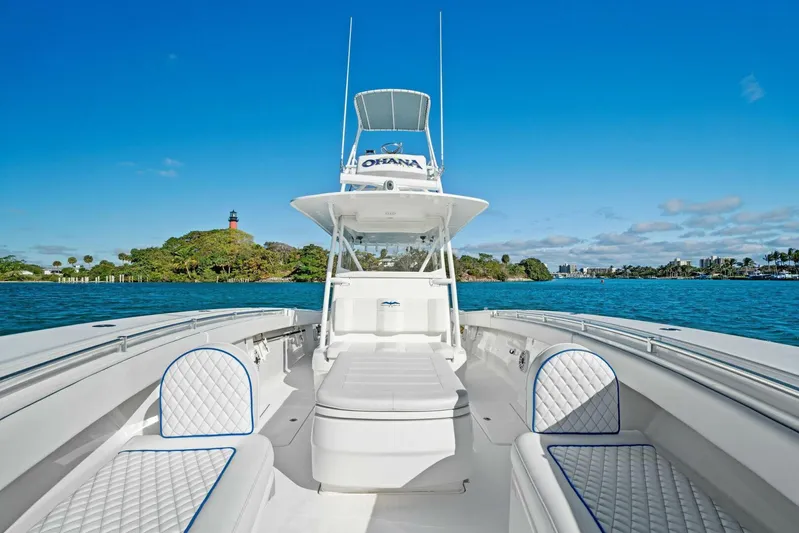 Ohana Yacht Photos Pics 2019 Invincible 42 Open Fisherman boat on clear blue water with island in background.