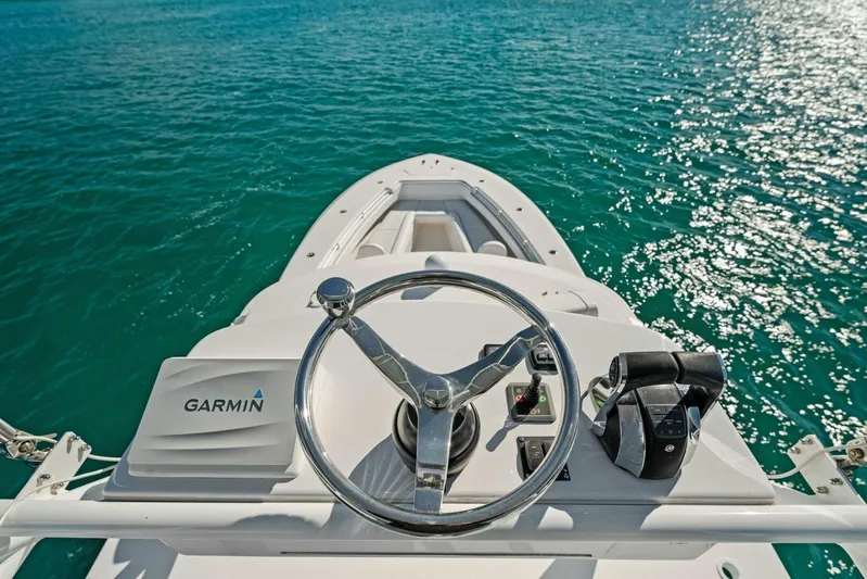Ohana Yacht Photos Pics 2019 Invincible 42 Open Fisherman boat helm with Garmin navigation system on clear blue water.