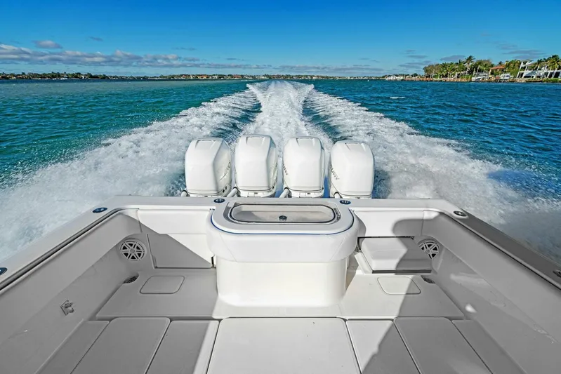 Ohana Yacht Photos Pics 2019 Invincible 42 Open Fisherman boat with quad outboard engines cruising on water.