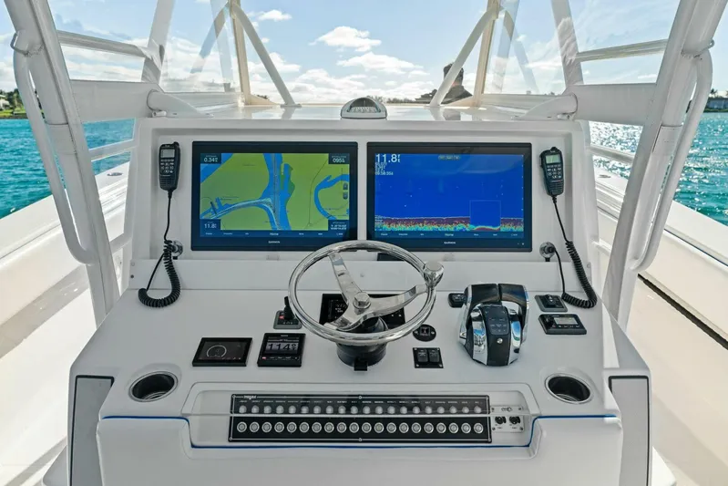 Ohana Yacht Photos Pics 2019 Invincible 42 Open Fisherman boat dashboard with dual navigation screens and controls.