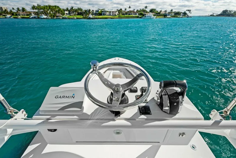 Ohana Yacht Photos Pics 2019 Invincible 42 Open Fisherman helm with Garmin navigation system on clear blue water.