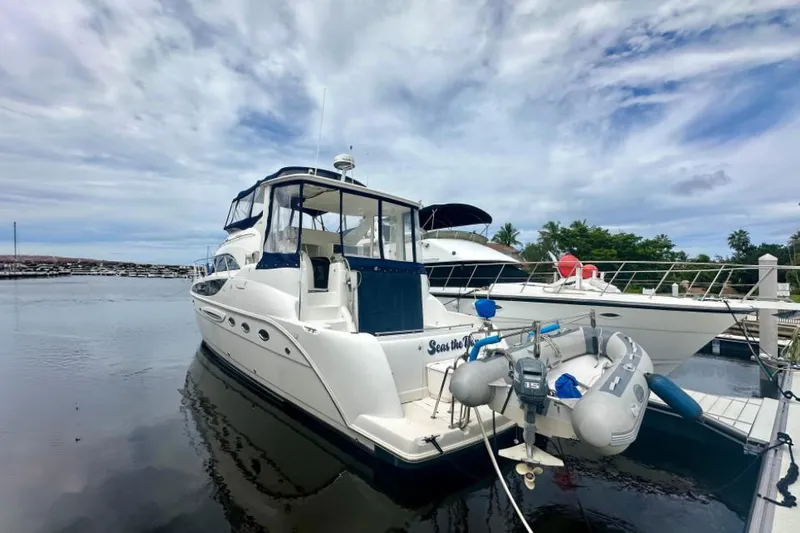 Seas The Day Yacht Photos Pics 2005 Meridian 459 Motoryacht docked at marina under cloudy sky.