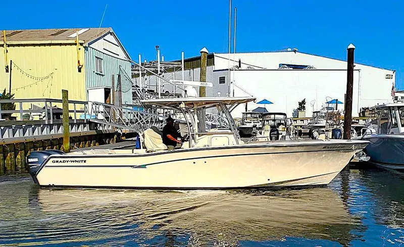  Yacht Photos Pics 2011 Grady-White Canyon 306 boat docked at marina, clear blue sky.