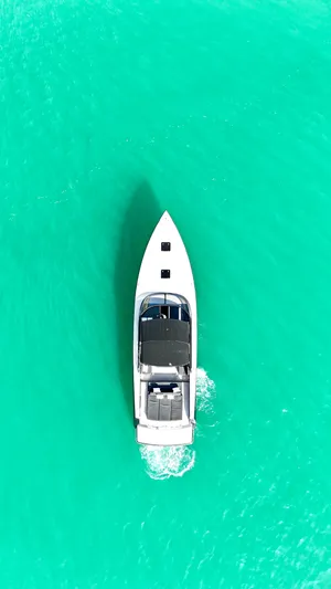 The Godfather Yacht Photos Pics Aerial view of 2014 VanDutch 55 yacht cruising on turquoise water.
