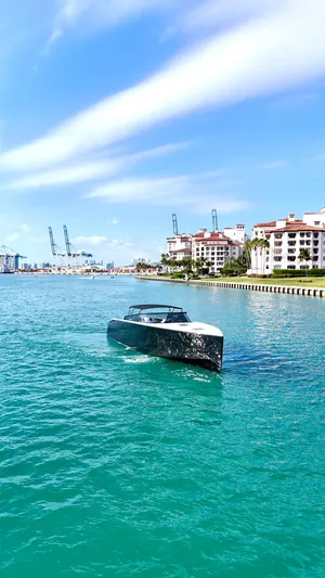 The Godfather Yacht Photos Pics VanDutch 55 yacht cruising in turquoise waters near luxury waterfront buildings, 2014 model.