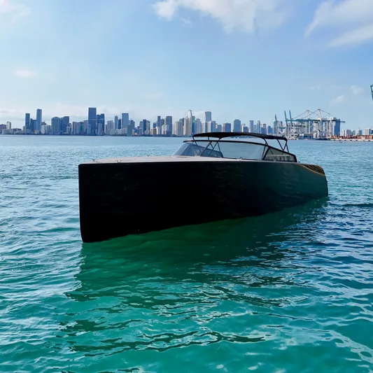 The Godfather Yacht Photos Pics VanDutch 55 yacht on turquoise water with city skyline in background, 2014 model.