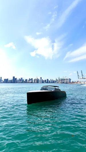The Godfather Yacht Photos Pics VanDutch 55 yacht on blue water with city skyline in background, 2014 model.