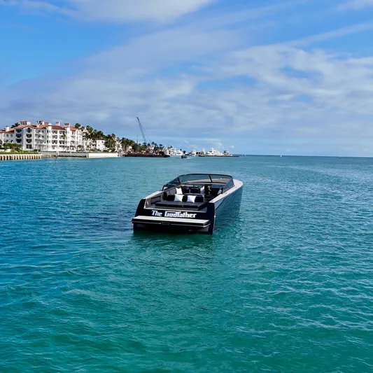The Godfather Yacht Photos Pics 2014 VanDutch 55 yacht cruising in clear blue waters near coastal buildings.