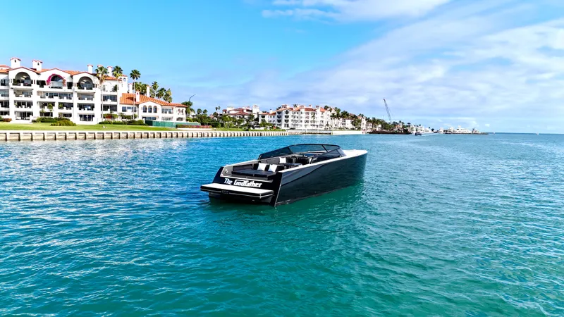 The Godfather Yacht Photos Pics 2014 VanDutch 55 yacht cruising near waterfront buildings under a clear blue sky.