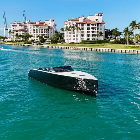The Godfather Yacht Photos Pics VanDutch 55 yacht cruising in turquoise waters near luxury waterfront buildings, 2014 model.