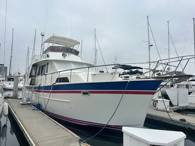 Day Light Yacht Photos Pics 1968 Hatteras 58 CPMY yacht docked at marina, featuring classic design and spacious deck.