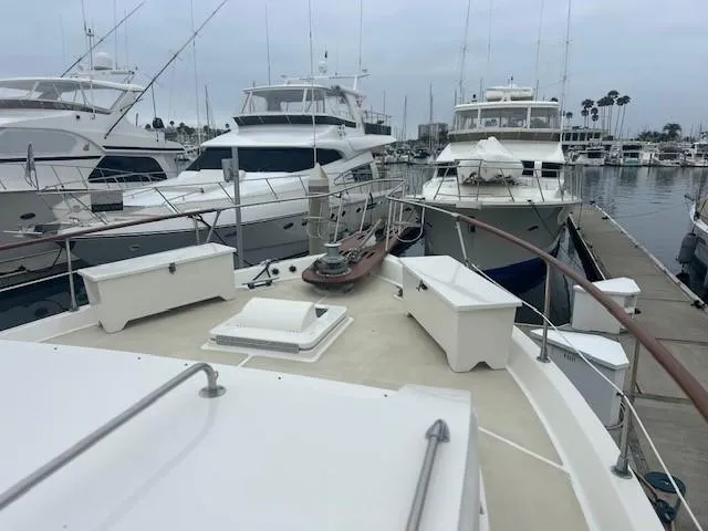 Day Light Yacht Photos Pics 1968 Hatteras 58 CPMY yacht docked in a marina with other boats.