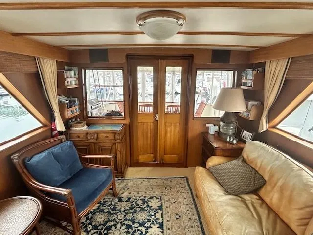 Day Light Yacht Photos Pics Interior of a 1968 Hatteras 58 CPMY yacht with wooden decor and cozy seating.