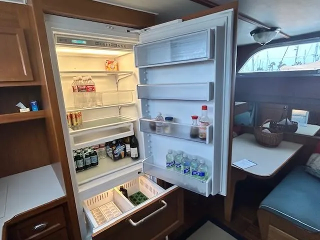 Day Light Yacht Photos Pics Open refrigerator inside 1968 Hatteras 58 CPMY yacht, stocked with beverages and condiments.