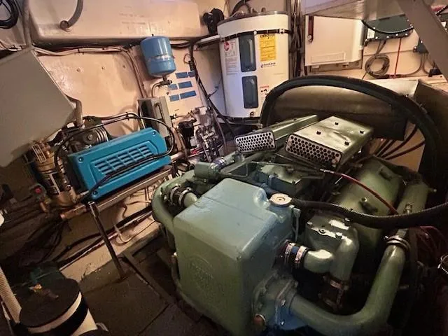 Day Light Yacht Photos Pics Engine room of a 1968 Hatteras 58 CPMY yacht, showcasing machinery and equipment.