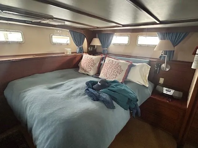 Day Light Yacht Photos Pics Cozy bedroom interior of 1968 Hatteras 58 CPMY yacht with blue bedding and nautical decor.