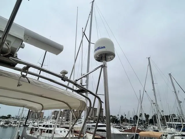 Day Light Yacht Photos Pics 1968 Hatteras 58 CPMY yacht with radar equipment in a marina setting.