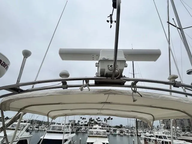 Day Light Yacht Photos Pics 1968 Hatteras 58 CPMY yacht radar and marina view under cloudy sky.